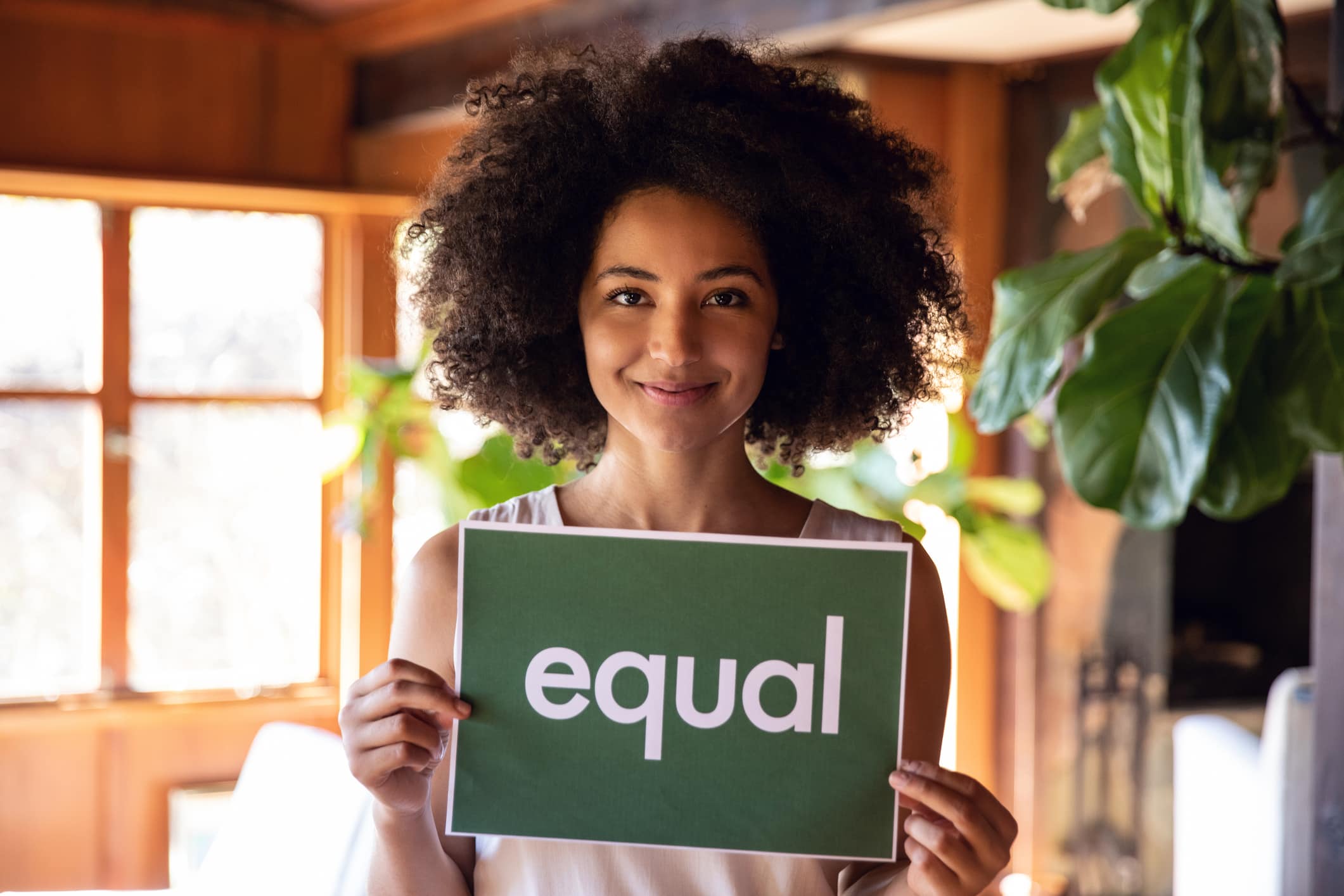 woman smiling with equal sign in her hands