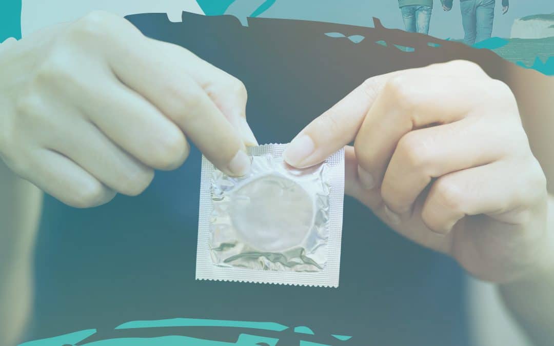 Condom in hands being opened